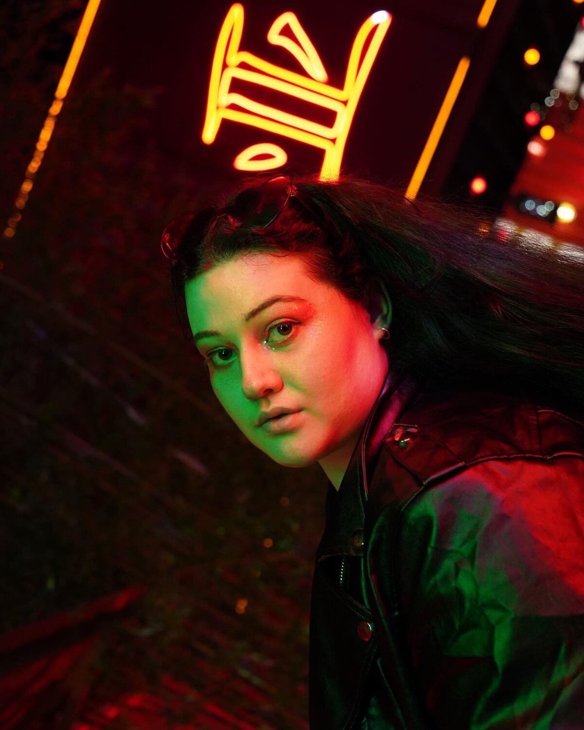Sarah McNally in a moody neon-lit portrait